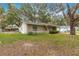 Landscaped yard with a large tree in front of the house at 55 Almond Rd, Ocala, FL 34472