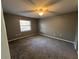 Spacious bedroom with gray walls, gray carpet, and ceiling fan at 6450 Nw 57Th Ave, Ocala, FL 34482