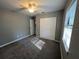 Spacious bedroom with gray walls, gray carpet, and ceiling fan at 6450 Nw 57Th Ave, Ocala, FL 34482