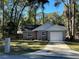 Newly built home with gray siding, white trim, and a driveway at 6450 Nw 57Th Ave, Ocala, FL 34482