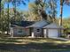 Newly constructed home with gray siding, white trim, and a two-car garage at 6450 Nw 57Th Ave, Ocala, FL 34482