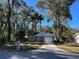 Newly built home with gray siding, white trim, and a driveway at 6450 Nw 57Th Ave, Ocala, FL 34482