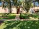 Attractive condo building with manicured landscaping and walkway at 674 Midway Dr # A, Ocala, FL 34472