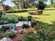 Relaxing patio with colorful flowers and sitting area at 674 Midway Dr # A, Ocala, FL 34472