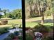 Peaceful screened patio overlooking a lush garden and golf course at 674 Midway Dr # A, Ocala, FL 34472