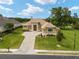 Luxury home with a large paved driveway and beautifully landscaped lawn at 7549 Nw 33Rd Pl, Ocala, FL 34482