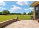 Landscaped backyard with golf course view and stone retaining wall at 7549 Nw 33Rd Pl, Ocala, FL 34482