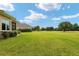 View of backyard, golf course, and manicured lawn at 7549 Nw 33Rd Pl, Ocala, FL 34482