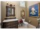 Powder room with decorative vanity and art at 7549 Nw 33Rd Pl, Ocala, FL 34482