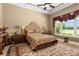 Spacious bedroom with large windows and golf course view at 7549 Nw 33Rd Pl, Ocala, FL 34482