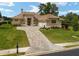 Tan house with tile roof, three-car garage, and landscaped yard at 7549 Nw 33Rd Pl, Ocala, FL 34482