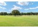 Expansive green golf course with lush trees at 7549 Nw 33Rd Pl, Ocala, FL 34482