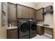 Laundry room with modern washer and dryer, ample cabinet space at 7549 Nw 33Rd Pl, Ocala, FL 34482