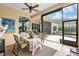 Screened patio with dining area and view into the home's interior at 7549 Nw 33Rd Pl, Ocala, FL 34482