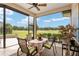 Relaxing screened-in patio with dining table and golf course view at 7549 Nw 33Rd Pl, Ocala, FL 34482