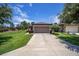 Single-story home with attached garage and well-manicured lawn at 7617 Sw 96Th Avenue Rd, Ocala, FL 34481