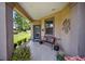 Covered porch with a bench, offering a relaxing spot to enjoy the outdoors at 7617 Sw 96Th Avenue Rd, Ocala, FL 34481