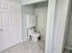 Bathroom with toilet and grab bar at 8009 County Road 109D, Lady Lake, FL 32159