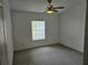 Bedroom with window and ceiling fan at 8009 County Road 109D, Lady Lake, FL 32159