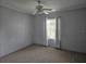 Bright bedroom with window and ceiling fan at 8009 County Road 109D, Lady Lake, FL 32159