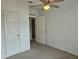 Bedroom with ceiling fan and carpet at 8009 County Road 109D, Lady Lake, FL 32159