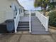 Large deck with ramp access and white railing at 8009 County Road 109D, Lady Lake, FL 32159