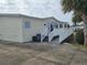 Single-story manufactured home with ramp and deck at 8009 County Road 109D, Lady Lake, FL 32159