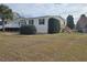 Single-story manufactured home with deck and fenced yard at 8009 County Road 109D, Lady Lake, FL 32159