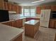 Open kitchen with island, lots of cabinets, and tile flooring at 8009 County Road 109D, Lady Lake, FL 32159