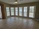 Sunroom with tile floors and wall-to-wall windows at 8009 County Road 109D, Lady Lake, FL 32159