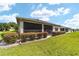 Home exterior showcasing a screened porch and landscaped backyard at 8230 Sw 78Th Cir, Ocala, FL 34476