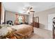 Bedroom with a post bed, dresser, and ceiling fan at 8230 Sw 78Th Cir, Ocala, FL 34476