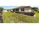 Side view of house with screened porch and well-manicured lawn at 8230 Sw 78Th Cir, Ocala, FL 34476