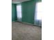 Bright bedroom with neutral carpeting and teal walls at 8340 Sw 108Th Place Rd, Ocala, FL 34481