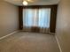 Bright bedroom with neutral walls, carpet, and large window with curtains at 8340 Sw 108Th Place Rd, Ocala, FL 34481