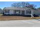 Front view of a single-story house with white siding and landscaping at 8340 Sw 108Th Place Rd, Ocala, FL 34481