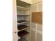 Walk-in pantry with ample shelving and a corkboard at 8340 Sw 108Th Place Rd, Ocala, FL 34481