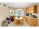 Charming kitchen dining area with a round table and wood chairs, near window at 8961 Sw 94Th Ln # C, Ocala, FL 34481