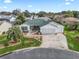 Single-story home with green roof, two-car garage, and landscaped yard at 9203 Se 179Th Lunsford Ln, The Villages, FL 32162