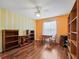 Home office with wood flooring and built-in shelving at 9203 Se 179Th Lunsford Ln, The Villages, FL 32162