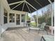 Relaxing screened patio with seating and a grill, perfect for outdoor enjoyment at 9203 Se 179Th Lunsford Ln, The Villages, FL 32162