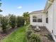 Landscaped side yard with a charming fountain at 9203 Se 179Th Lunsford Ln, The Villages, FL 32162