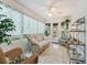 Relaxing sunroom with wicker furniture and tiled flooring at 9203 Se 179Th Lunsford Ln, The Villages, FL 32162