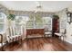 Bright sunroom with hardwood floors and ample natural light at 9203 Se 179Th Lunsford Ln, The Villages, FL 32162