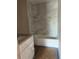 New bathroom featuring a shower and tub combination with elegant marble-look tile and granite vanity at 10538 Se 50Th Ave, Belleview, FL 34420