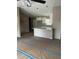 Open-concept living space with eat in bar and granite countertops, ready for finishing touches at 10538 Se 50Th Ave, Belleview, FL 34420