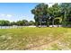 Expansive backyard featuring a lush green lawn and a pristine white fence, perfect for outdoor activities and privacy at 10871 Sw 62Nd Avenue Rd, Ocala, FL 34476
