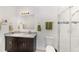 Bright bathroom featuring a double sink vanity with granite countertops and tiled walk-in shower at 10871 Sw 62Nd Avenue Rd, Ocala, FL 34476
