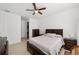 Bright bedroom featuring a dark wood bed, ceiling fan, and ample space, offering comfort and style at 10871 Sw 62Nd Avenue Rd, Ocala, FL 34476