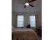 Bedroom with a queen bed and ceiling fan at 10871 Sw 62Nd Avenue Rd, Ocala, FL 34476